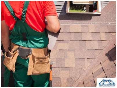 A man working on a shingle roof.
