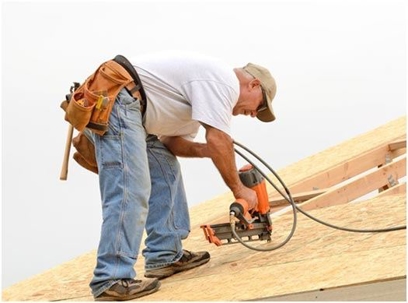 A man installing a roof.