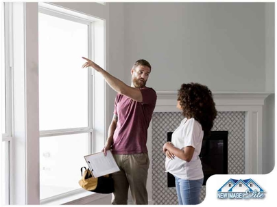A worker and woman looking at a window.