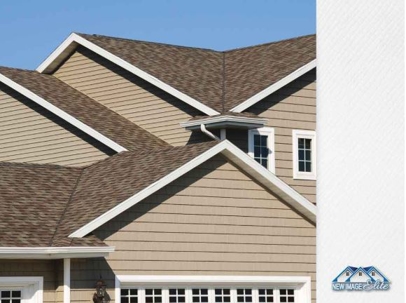 A brown roof on a tan sided home.